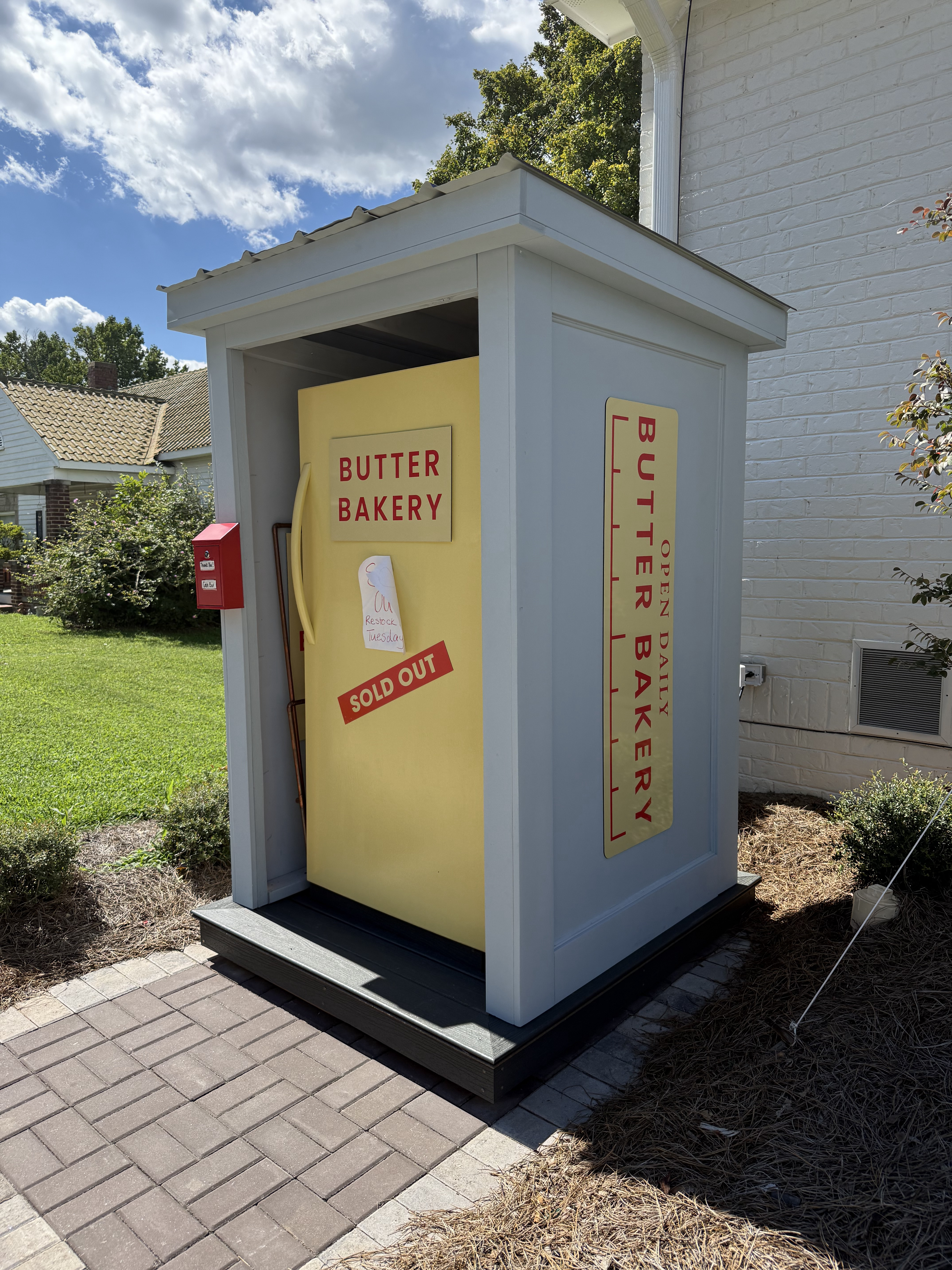 The Butter Bakery stand in Clayton, a yellow fridge painted like a beautiful stick of butter, with a Sold Out notice taped to the door